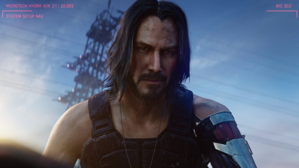 Johnny Silverhand in Cyberpunk 2077. Johnny stares at the player with a blue sky behind him.