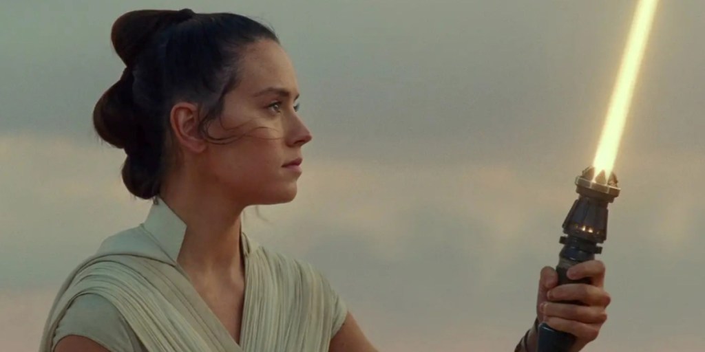 Rey ignites her yellow lightsaber in Star Wars: The Rise of Skywalker's final scene