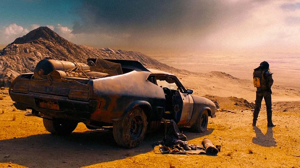 Max Rockatansky standing next to his V8 Interceptor in Mad Max: Fury Road