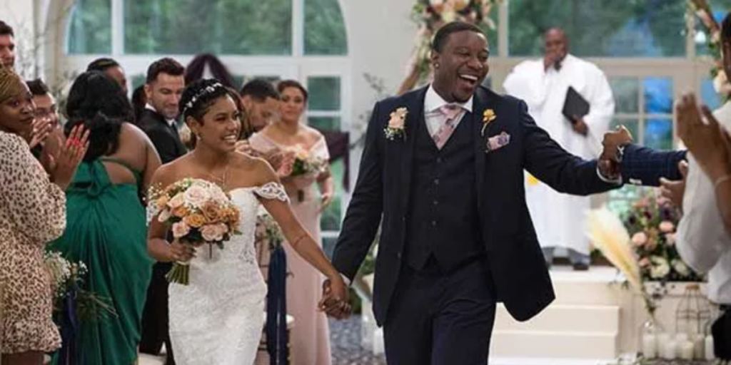 Love is Blind's Jarrette Jones and Iyanna McNeely holding hands on the aisle at their wedding.