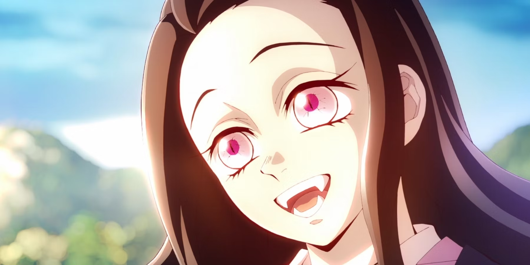 Nezuko smiles, showing her fangs
