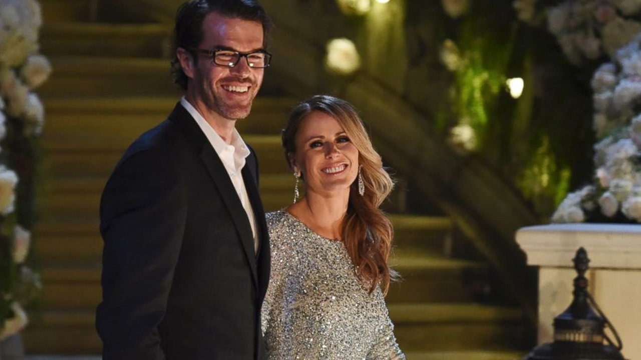 Trista and Ryan Sutter from The Bachelor, walking and smiling.