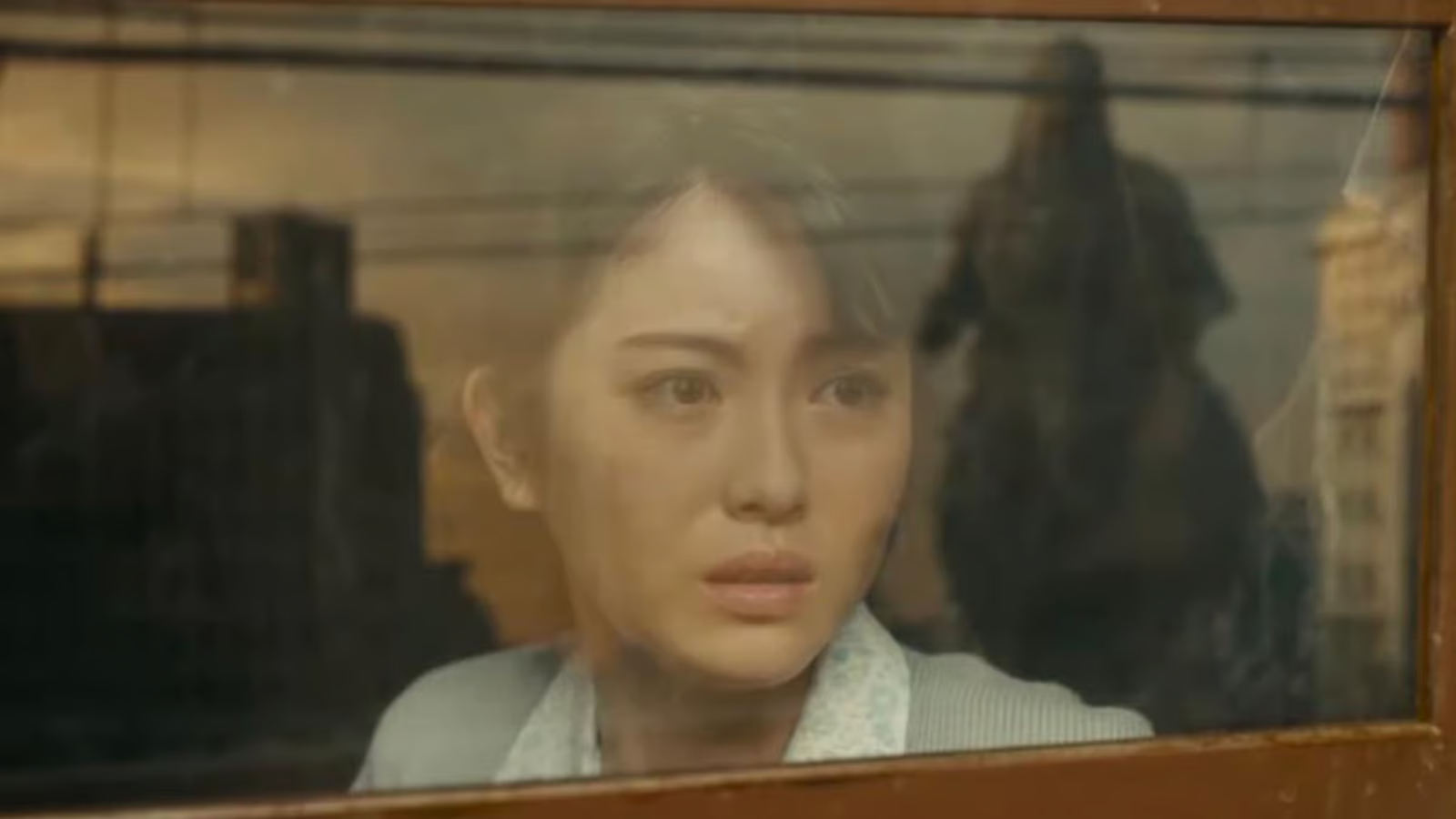 Noriko watching Godzilla approach through a train carriage window in Godzilla Minus One