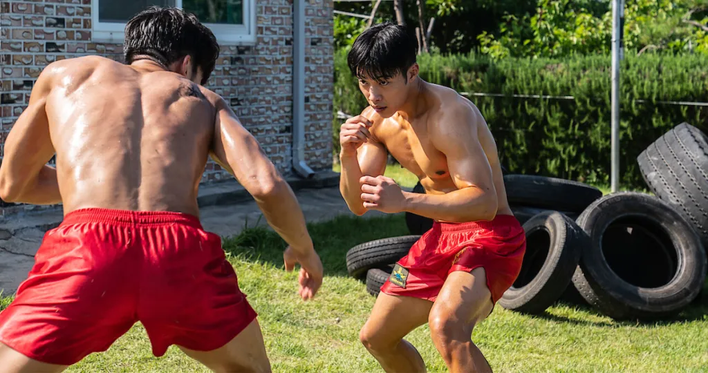 Kim Geon-woo spars in a backyard. This image is part of an article about whether there will be a Bloodhounds Season 2.