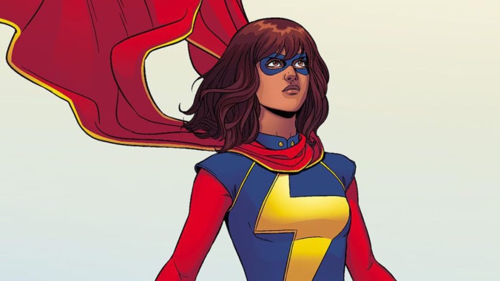 Ms Marvel stands with her scarf blowing in the wind