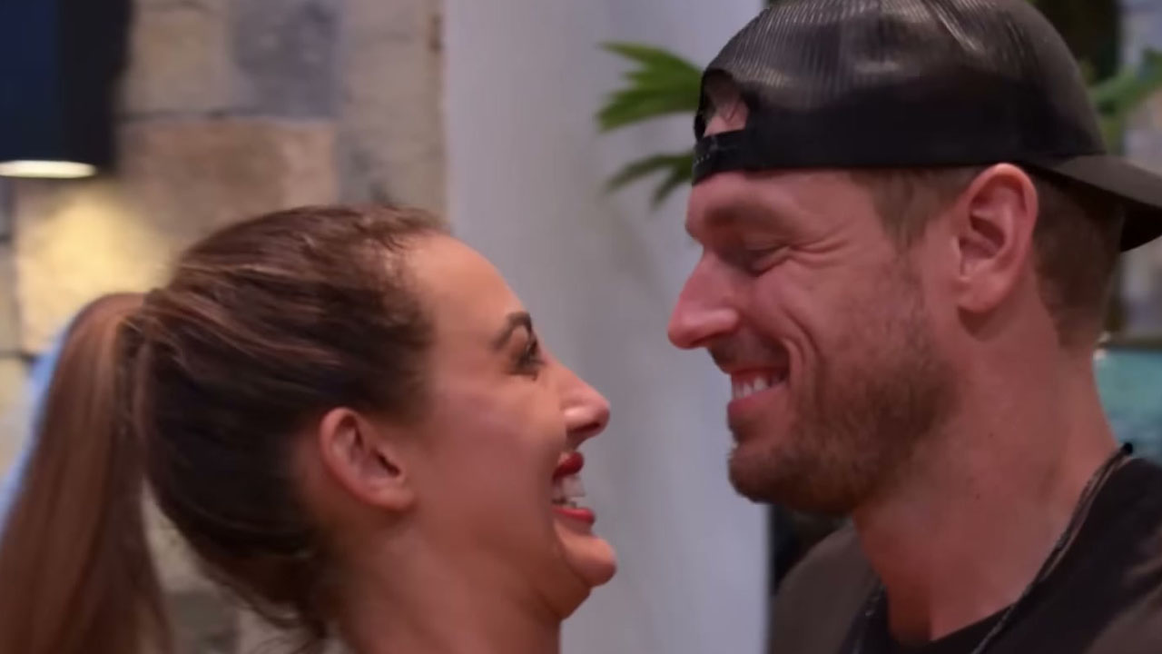 Shane and Chloe from Perfect Match, smiling at each other.