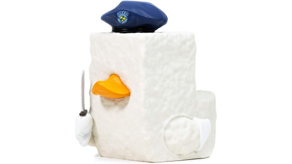 A Resident Evil figure of Tofu, a block of Tofu with a duck's bill, a hat and a knife. 