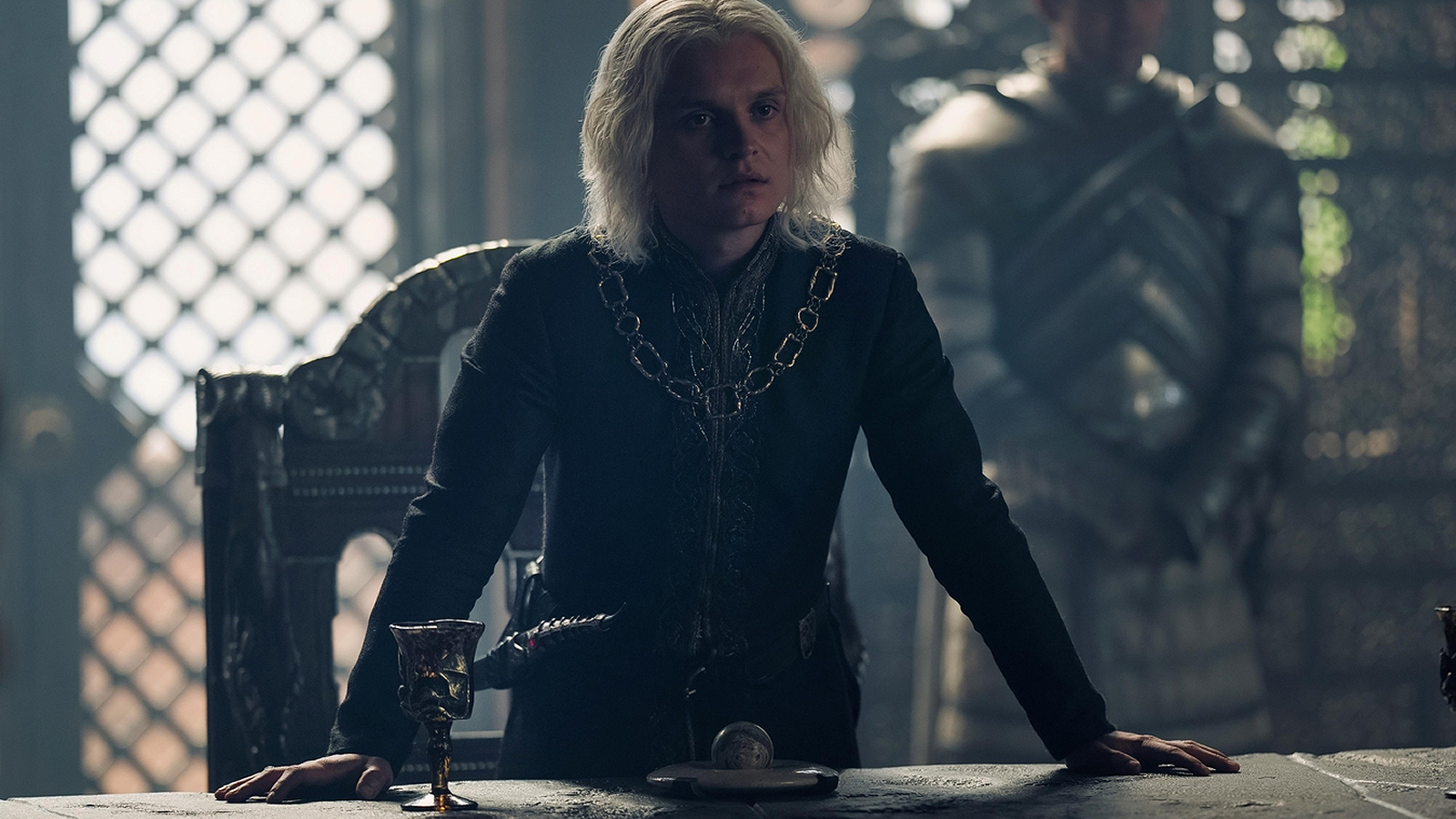 Aegon II Targaryen standing at the Small Council table in House of the Dragon Season 2, Episode 4