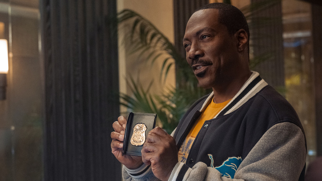 Beverley Hills Cop: Axel F, Axel Foley holding up his police badge.