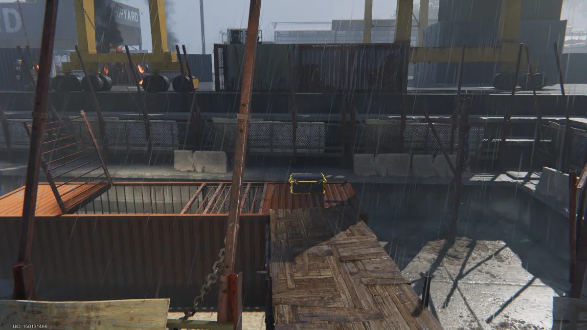 Image of a recessed pier full of cargo crates on their side and plywood platforms, a glowing gear crate in the back