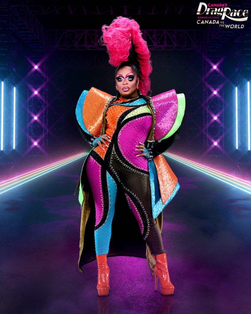 Kennedy Davenport posing in a full skin tight suit with a range of colors and prominent geometric sleeves and a massive mohawk in Canada vs The World