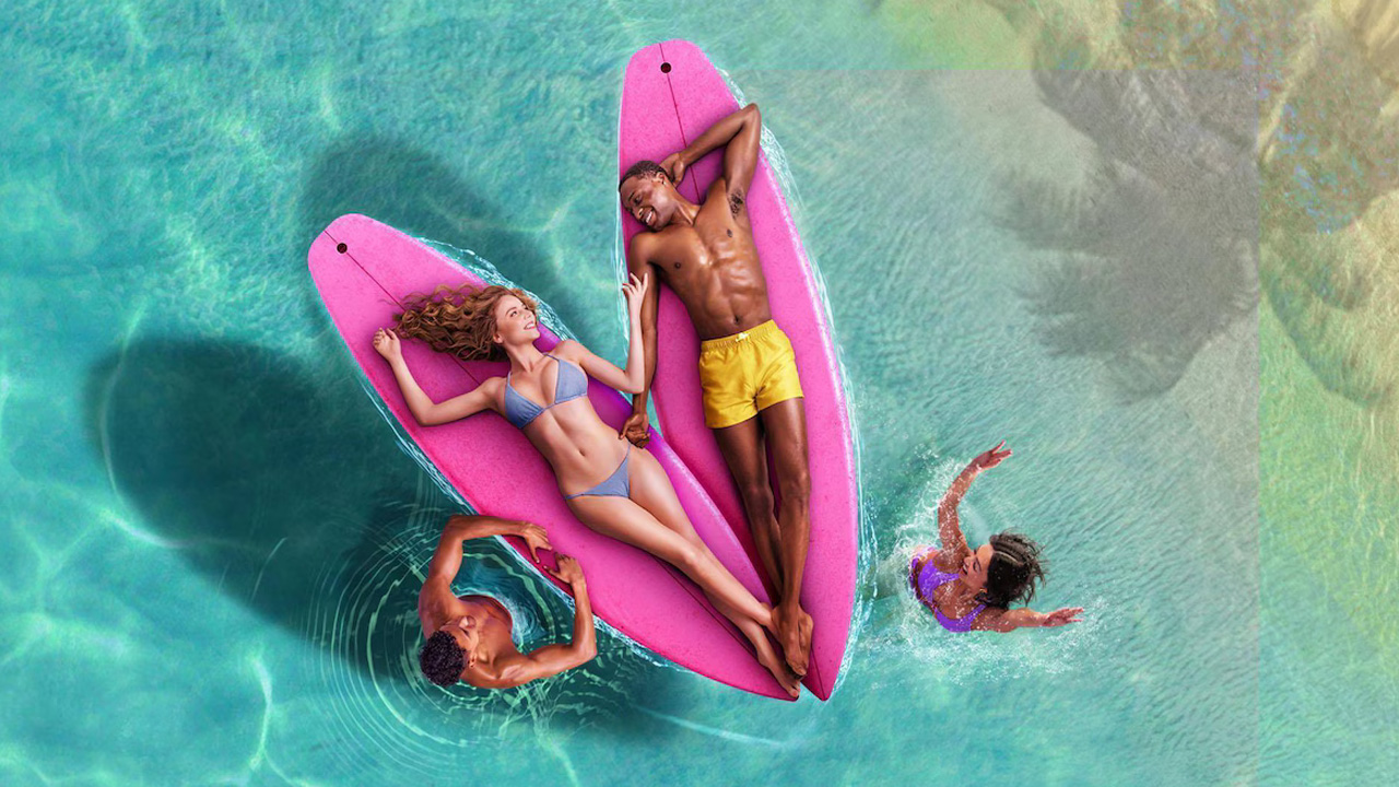 Love Island USA, a top down view of a couple laying back on surfboards on the ocean.