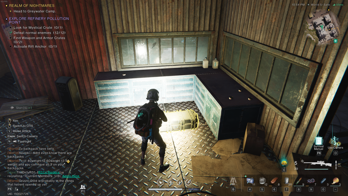 The player stands in a grimy warehouse with a weapon crate tucked in a corner near green industrial cabinets