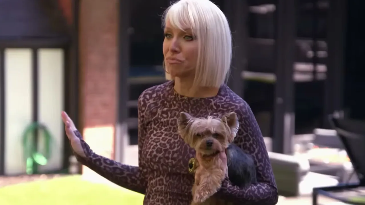 Margaret Josephs from Real Housewives of New Jersey, standing by a pool holding a dog.