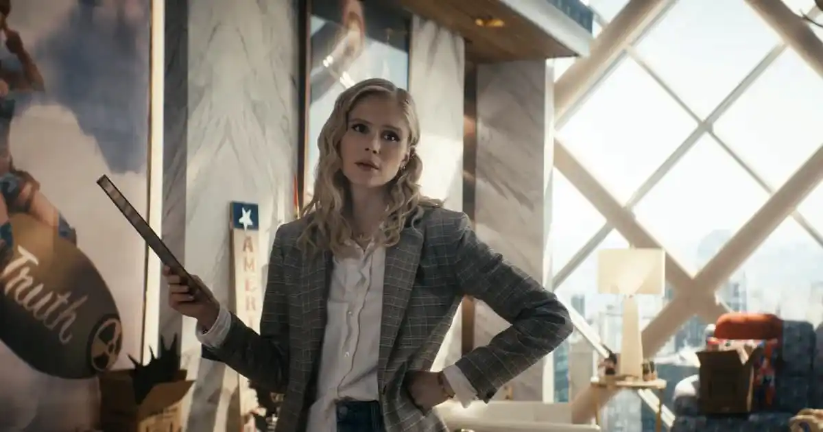 a still of starlight in vought tower in the boys season 4, a hand on her hip and a tablet in her hands, staring at someone off screen