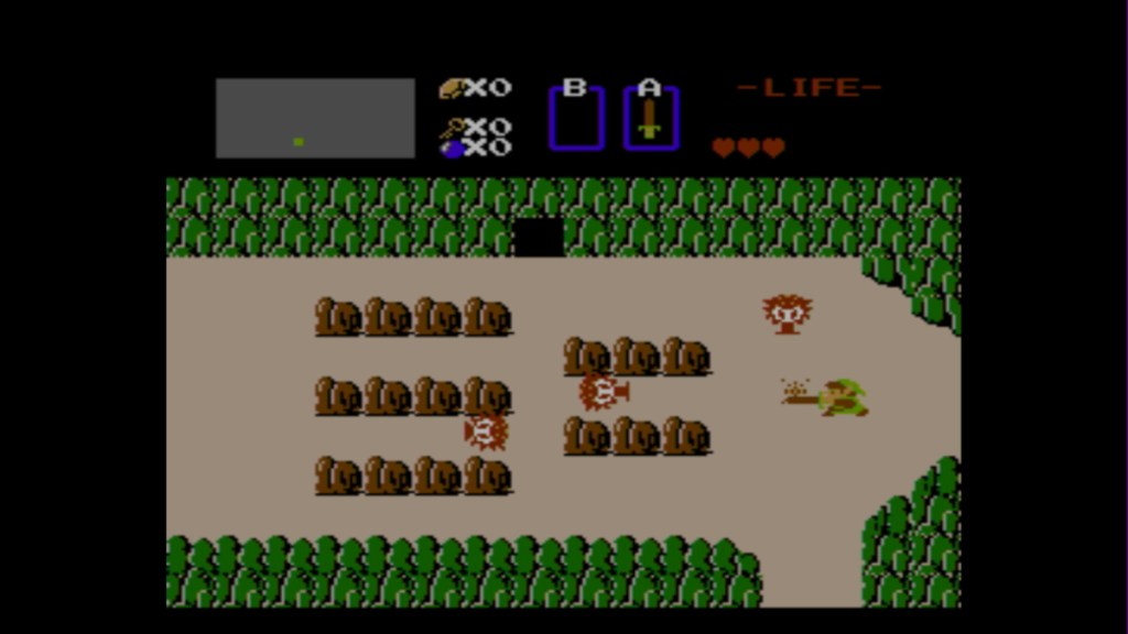 a screenshot of the original legend of zelda link battling octoroks