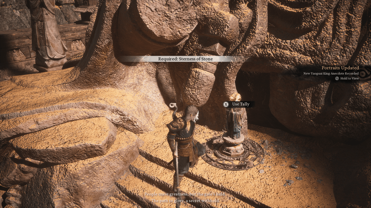 Image of Wukong standing in front of a statue with text that says Required: Sterness of Stone in a rocky area