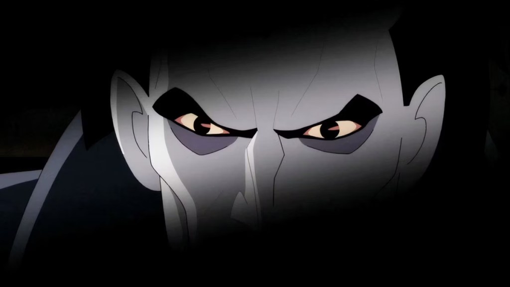 Image of the Joker glaring at the viewer, his eyes flanked in an ombre black in Batman: Caped Crusader Season 1, Episode 10