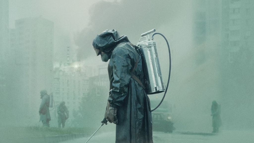 Key art for HBO miniseries Chernobyl, featuring a person in a quarantine suit in a greyed out city street