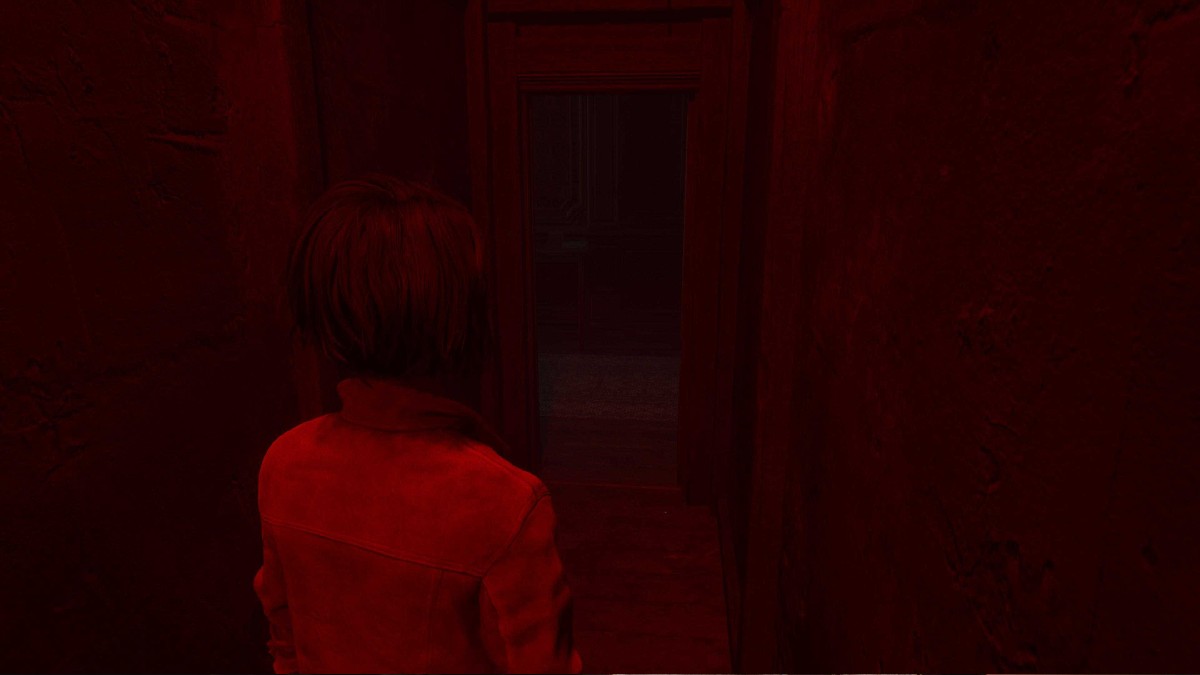 The exit of the secret hallway bathed in red light