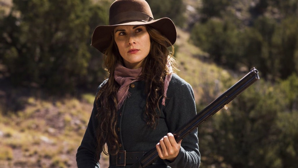 Michelle Dockery as Alice Fletcher in Netflix's Godless, holding a shotgun and staring down someone off screen