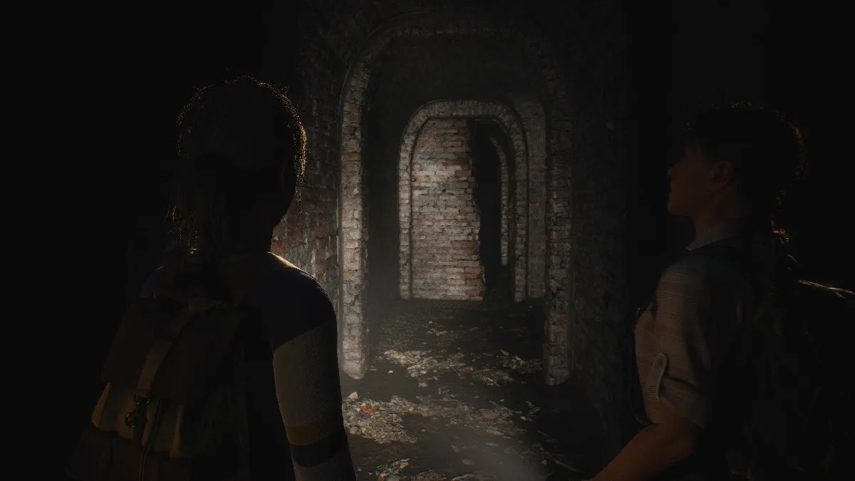 A claustrophobic hallway made of brick stretches in front of the protagonist, lit only by flashlight