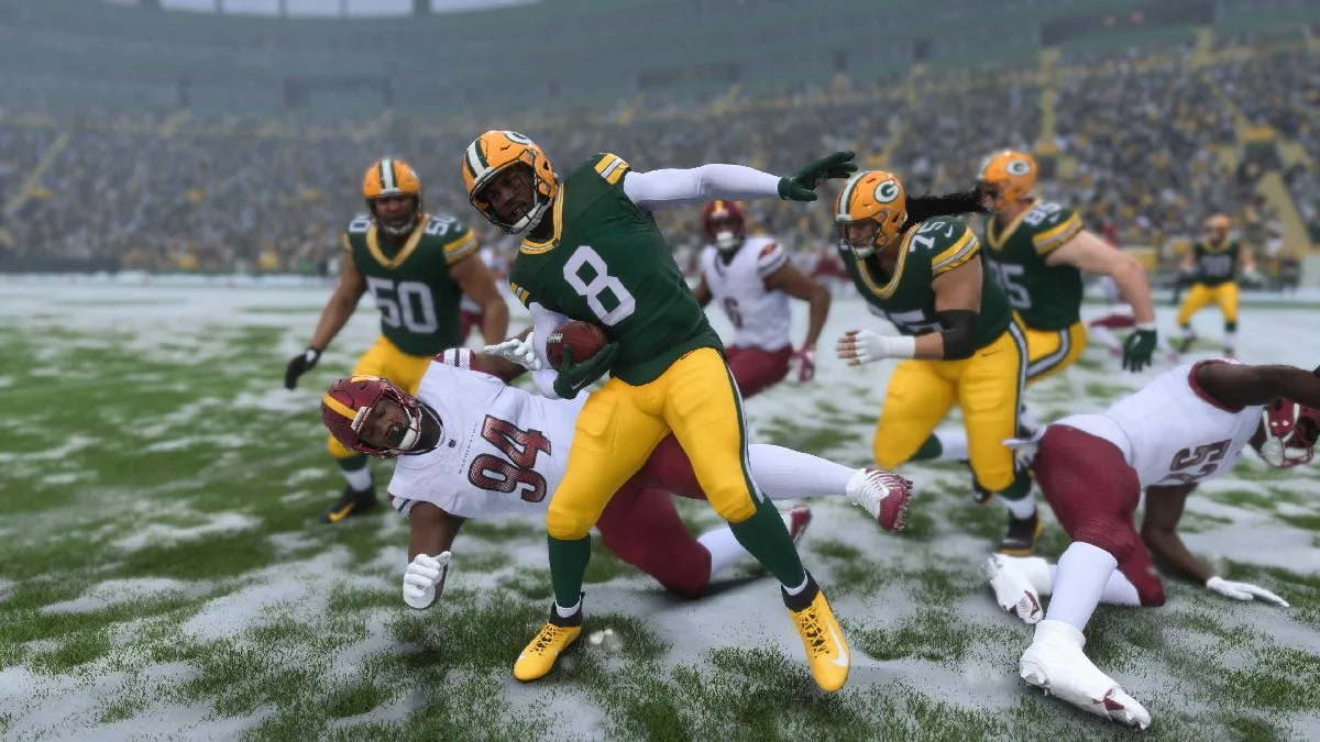 A photo of a Green Bay Packers player spinning out someone on the Washington Commanders team in the snow in an article reviewing the game