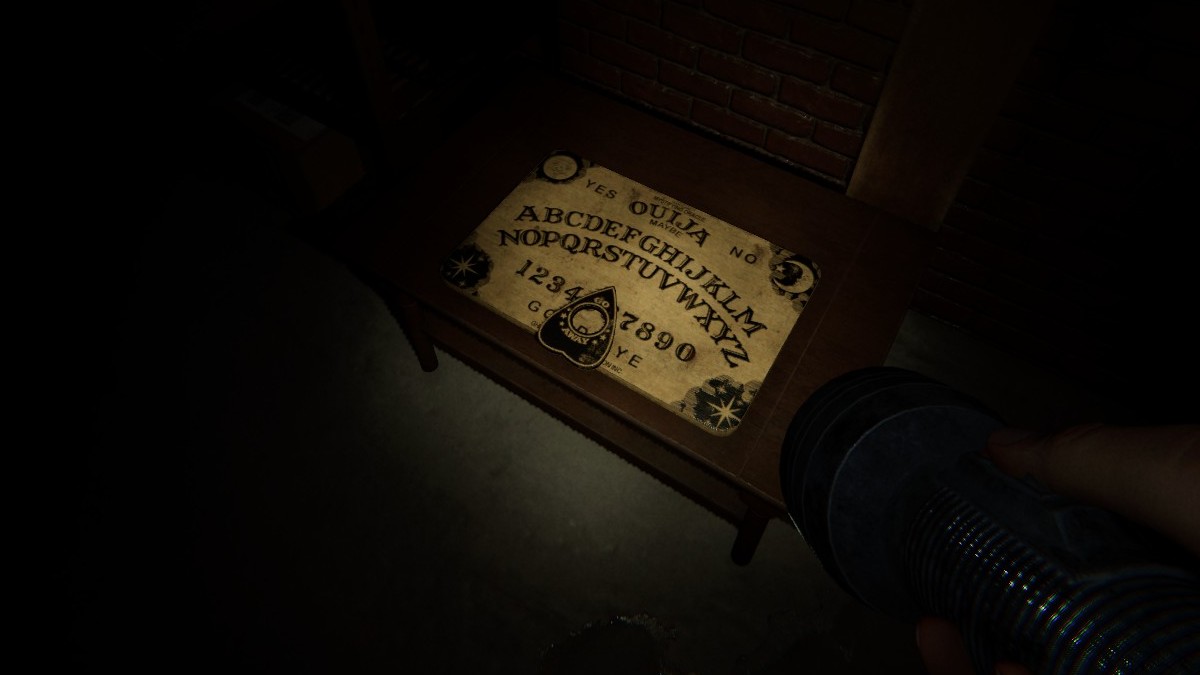 An activated Ouija Board in Phasmophobia in an article detailing the questions you can ask it in the game