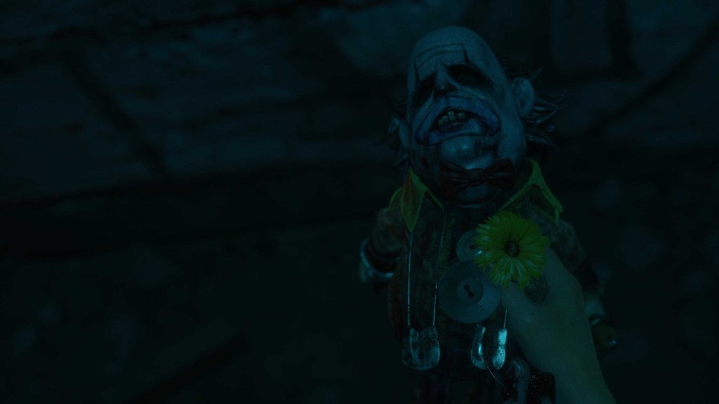 A photo of The Clown Rellik held up in the dark, featuring a comically large head