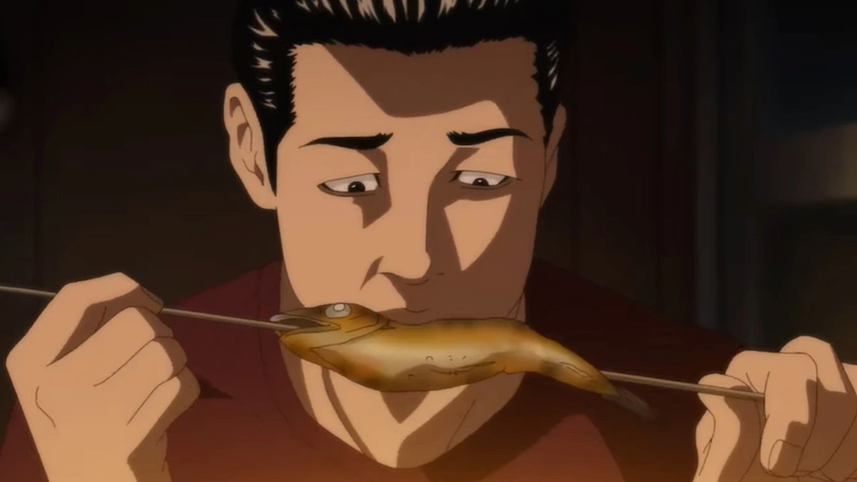 Image of a man forlornly eating a skewered roasted fish