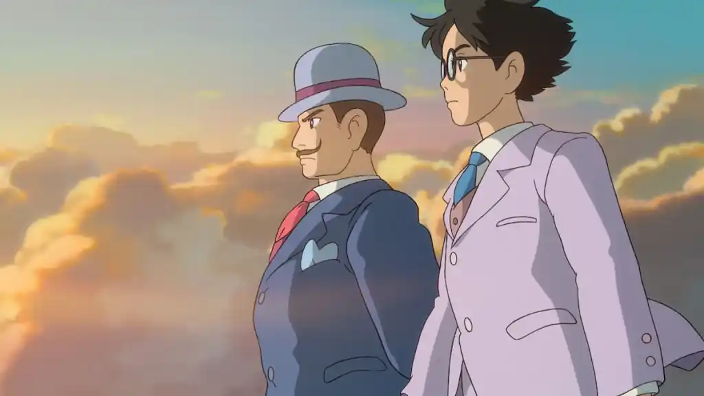 Two men stand looking over an unseen horizon with golden clouds behind them in anime movie The Wind Rises