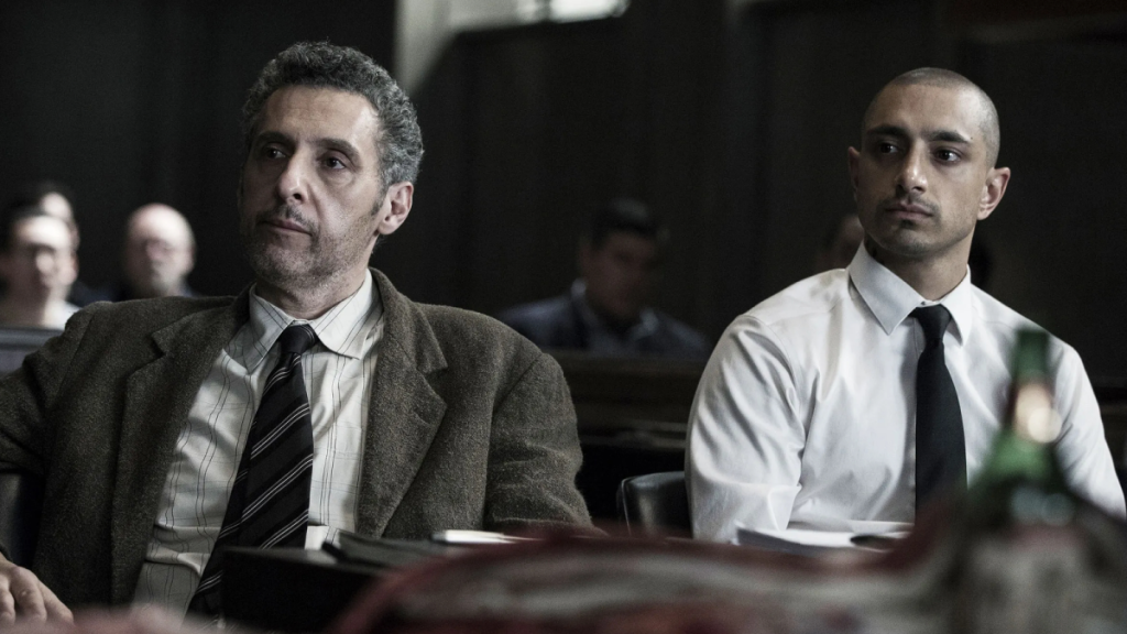 John Turturro and Riz Ahmed in The Night Of, sitting in what might be a courtroom