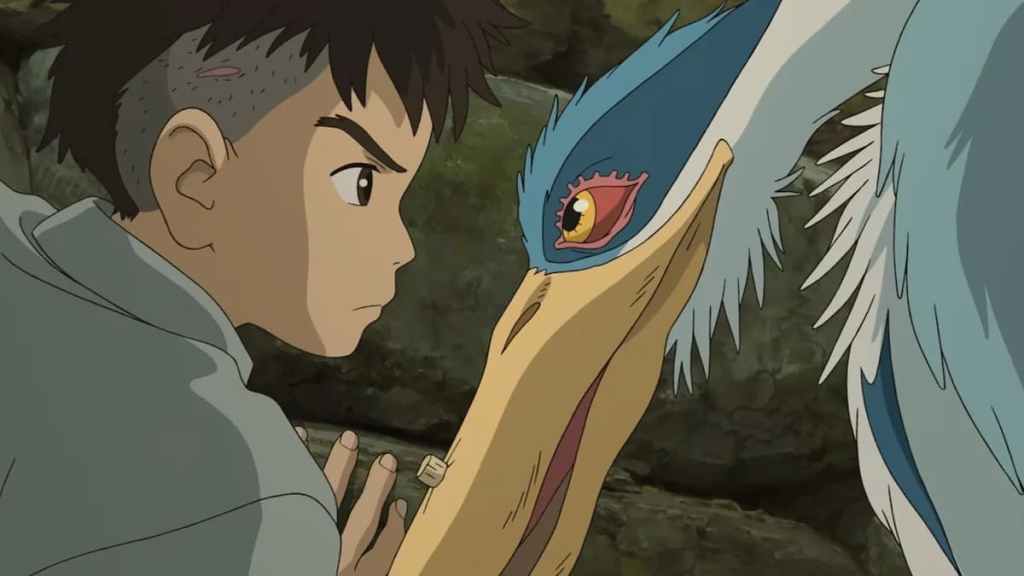 A boy with half his head shaved glares at a heron in anime movie The Boy and the Heron