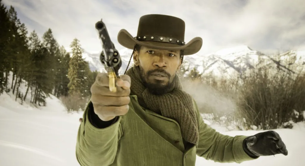 Django aims his revolver in the snow