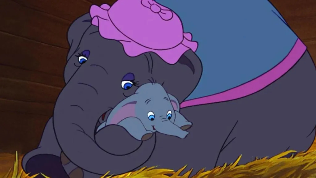 Dumbo is hugged by his mother