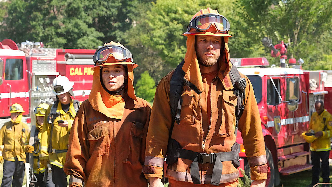 Fire Country, two tired-looking firefighters.