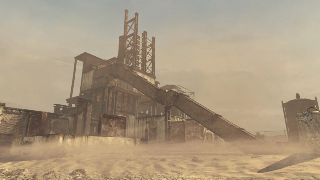 image of a large towering metal structure in the middle of a red, sandy desert