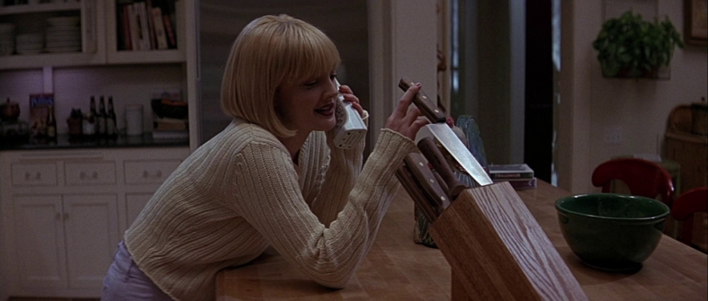 Drew Barrymore in Scream (1996), featuring her messing with the handle of a knife in a kitchen