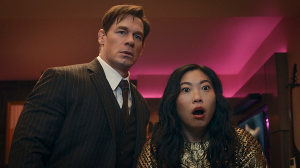 Noel (John Cena) and Katie (Awkwafina) in Jackpot, looking shocked.