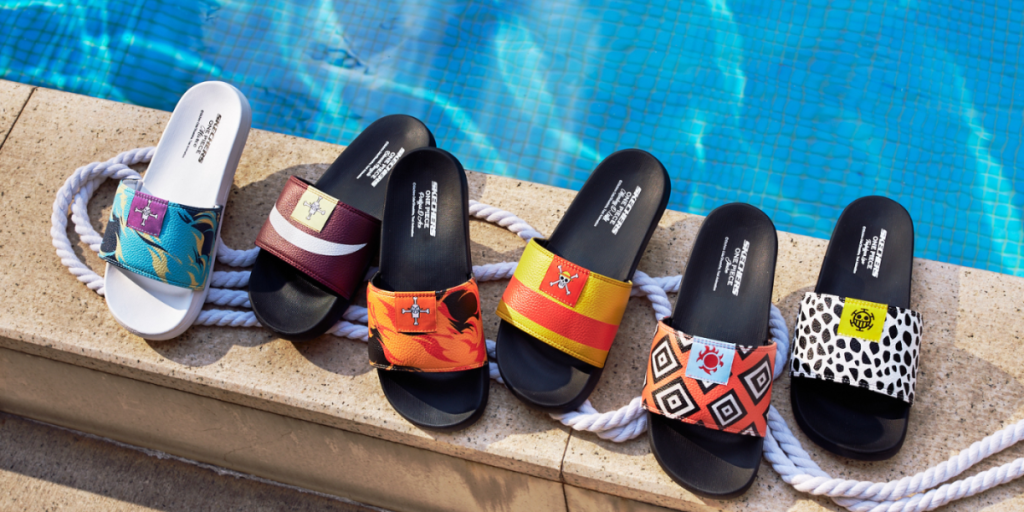 An assortment of colorful flipflops (or slides) with One Piece logos on a white rope beside a pool