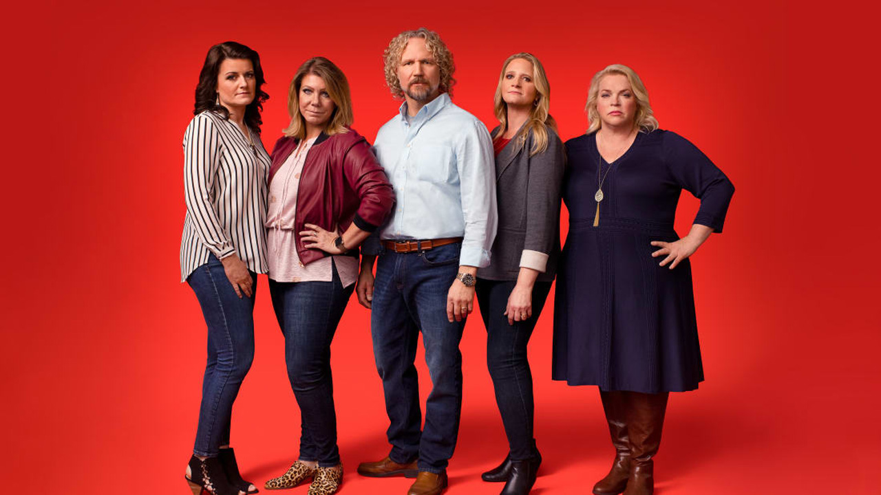 Sister Wives, the cast against a red background, looking grumpy.