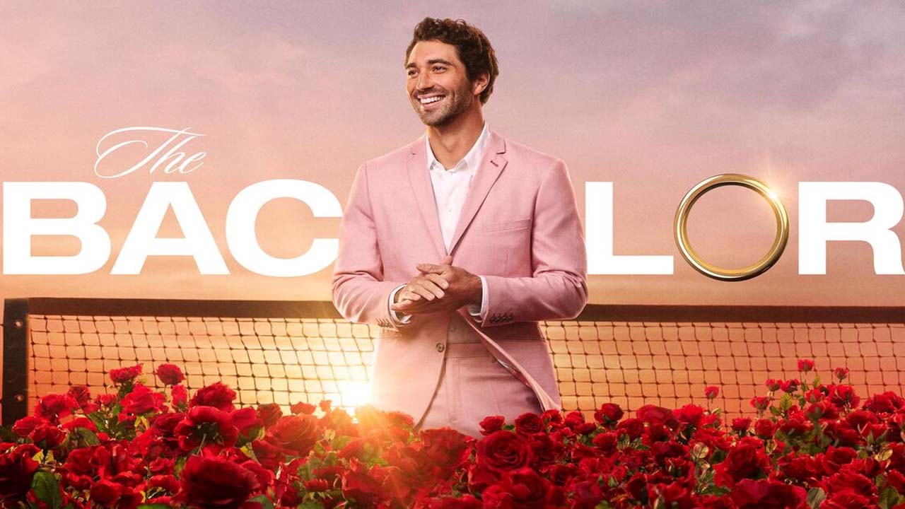 The Bachelor, a man standing in front of The Bachelor logo.