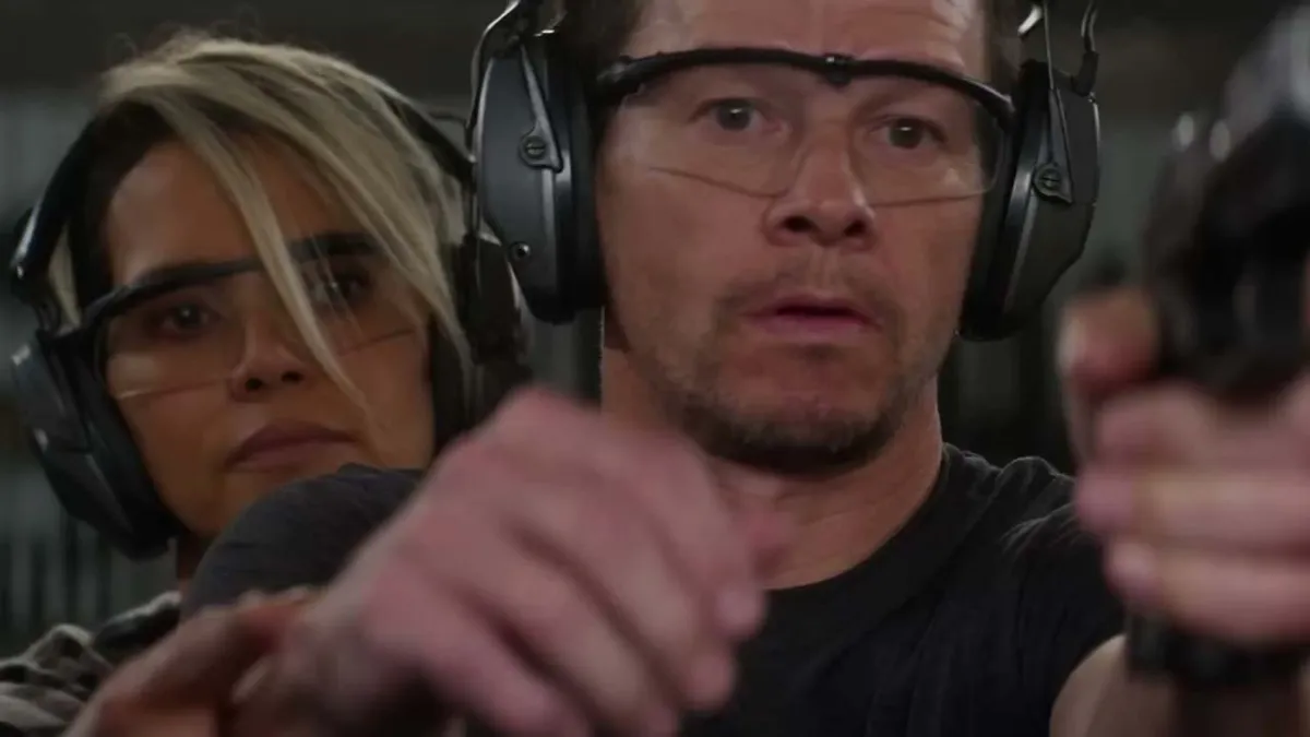 The Union, Roxanne teaching Mike to shoot as she stands behind him, with sound suppressors on both their ears