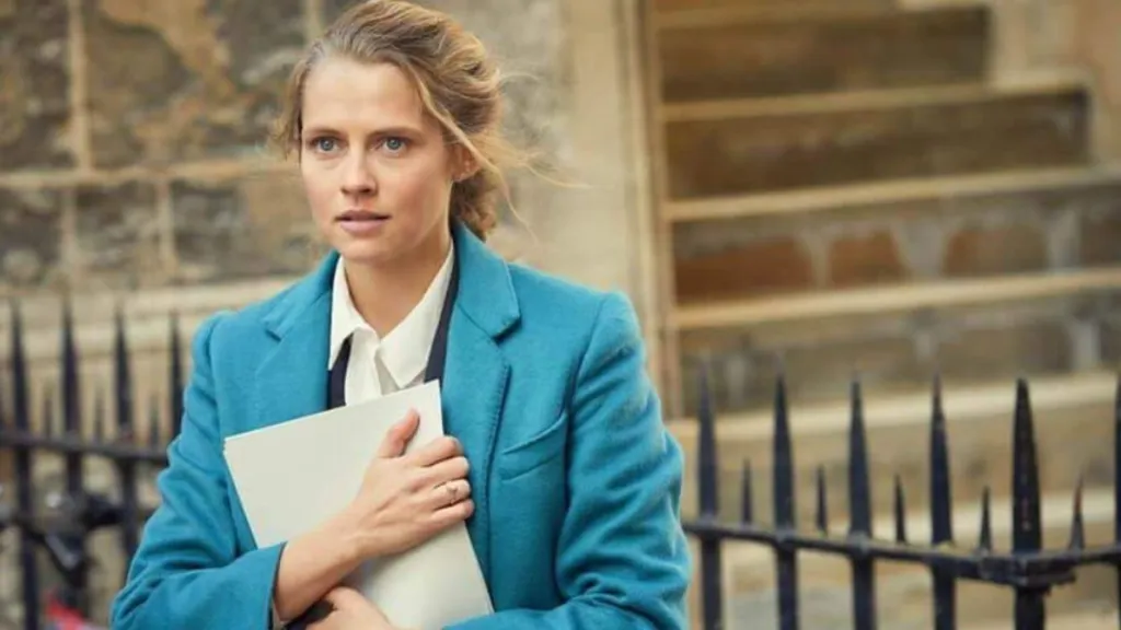 Diana Clutching Papers and looking thoughtful in the show Discovery of Witches