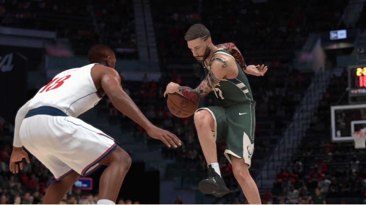 Image of two basketball players on the field, with one in a green jersey attempting to move around another with a ball in hand in NBA 2K25