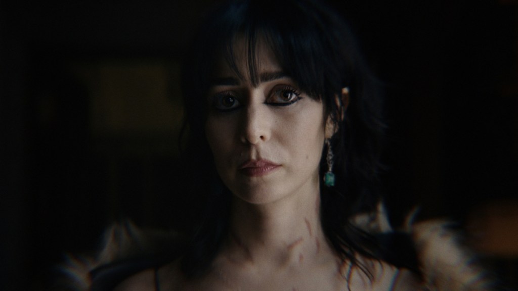 Cristin Milioti as Sofia Falcone in The Penguin staring off screen against a dark background