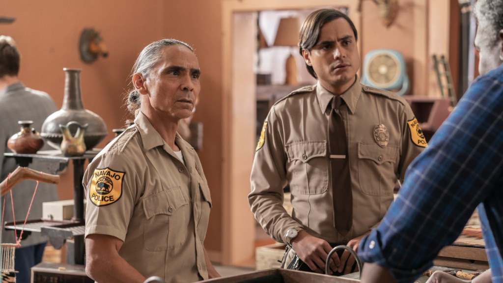 Zahn McClarnon and Kiowa Gordon stand in a gift shop in Dark Winds.