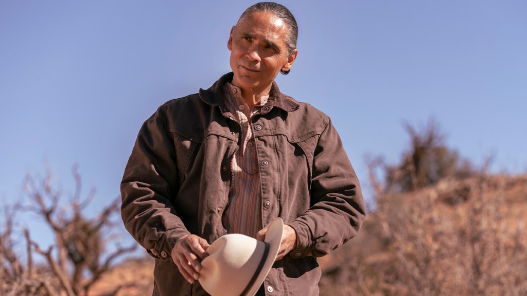 Zahn McClarnon holds a cowboy hat in Dark Winds.