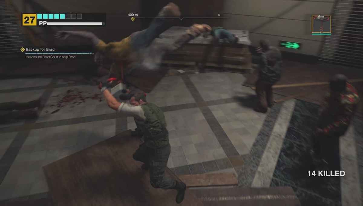 Frank West killing a Dead Rising Deluxe Remaster zombie with a giant drill. 