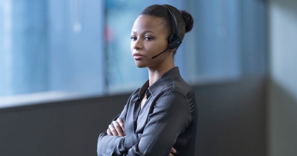 Harper wears a headset in an office in Industry